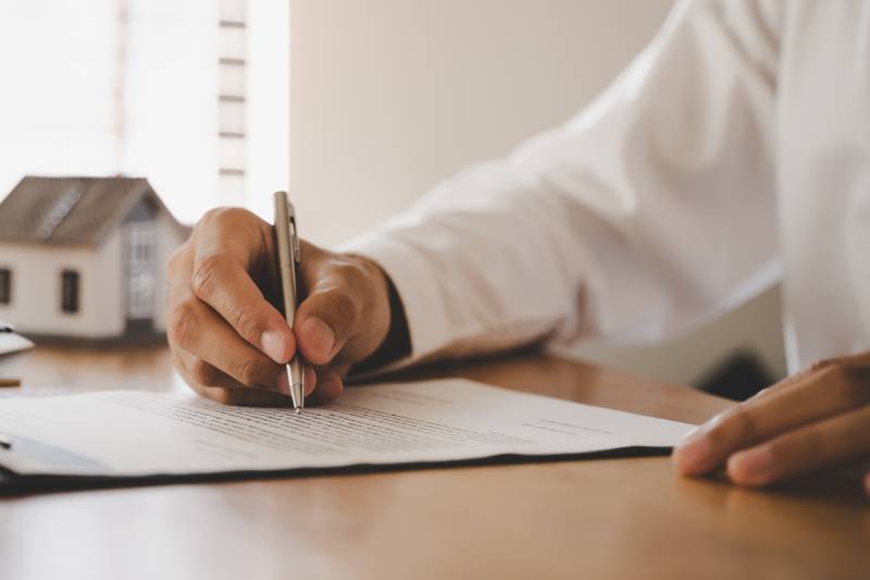 Landlord reviewing insurance contract with advisor 